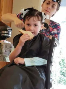 in home lice treatment and lice removal on a young girl