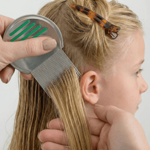 Lice removal product combing on a young girl
